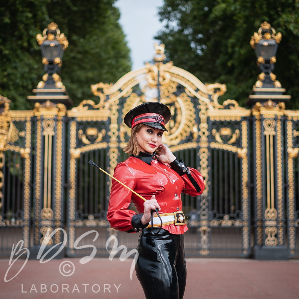Mistress Miranda in front of Buckingham Palace, London dressed in latex catsuit for a Decadent London photoshoot.