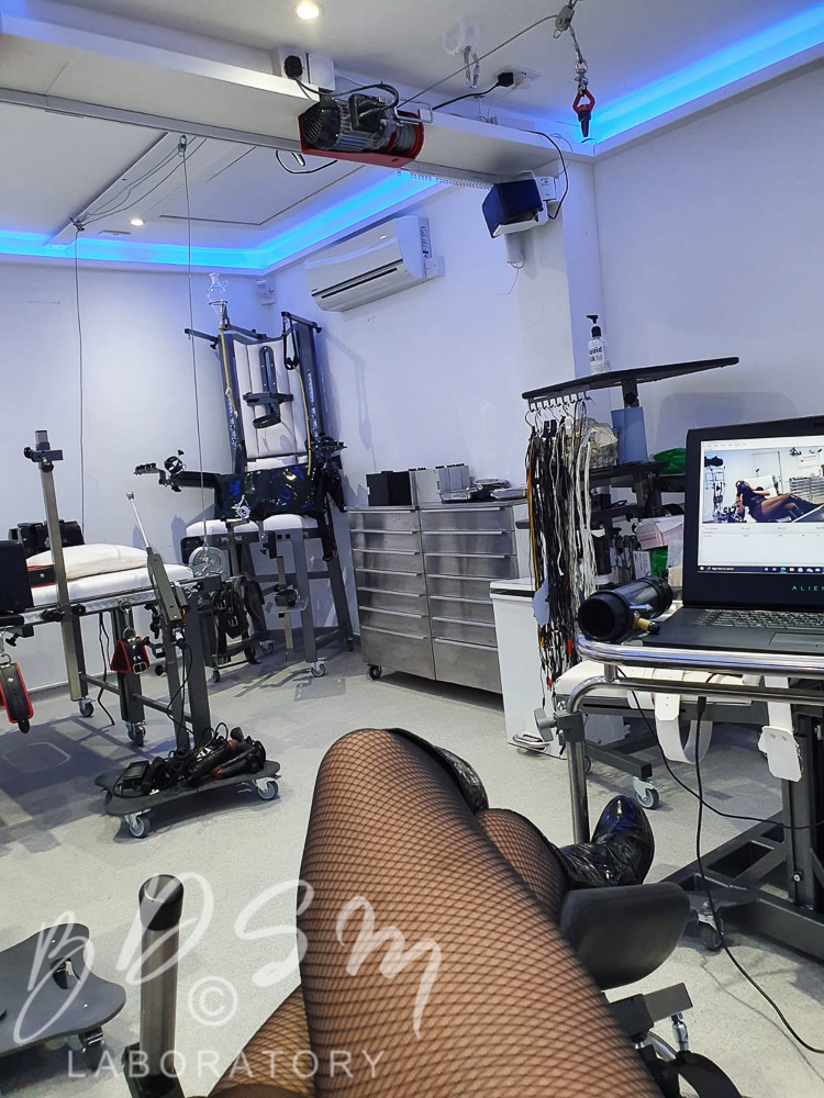 Kinky Webcam BDSM play with Mistress Miranda 1 Mistress Miranda's legs with the BDSM Laboratory fetish equipment in the background