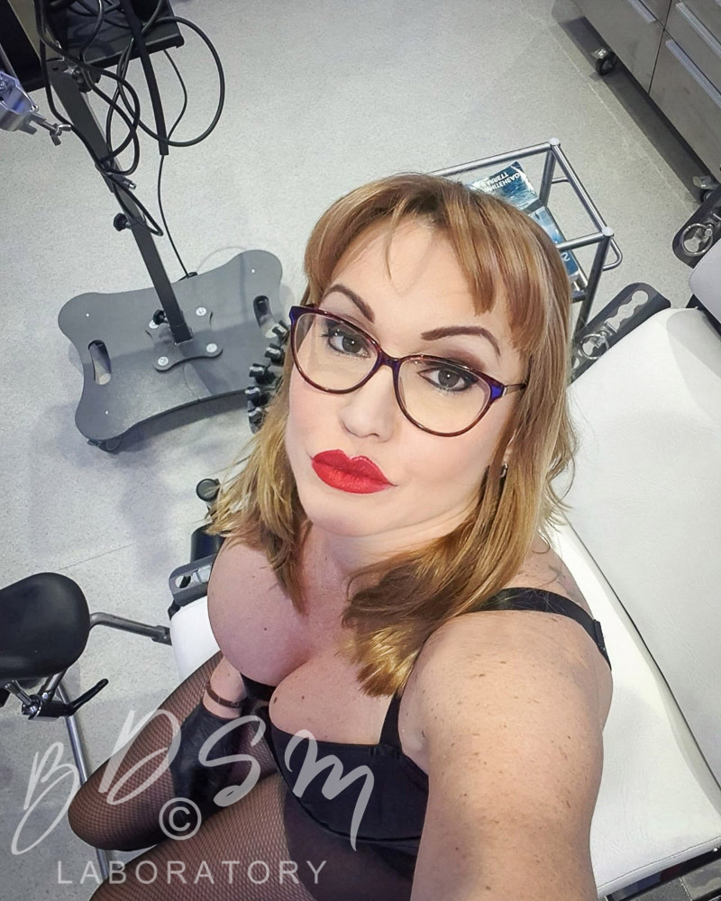 Kinky Webcam BDSM play with Mistress Miranda 4 Mistress Miranda wearing glasses and looking up to the camera
