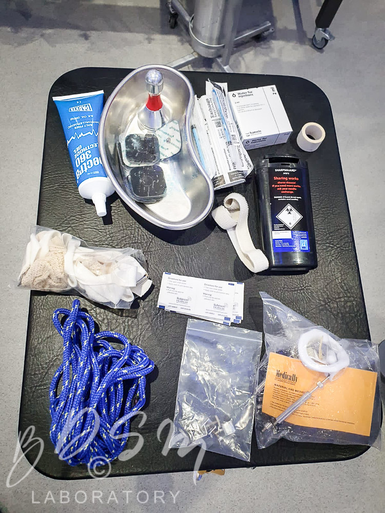 Kinky Nurse Katy 5 Various BDSM medical equipment laid out on a rubber mat