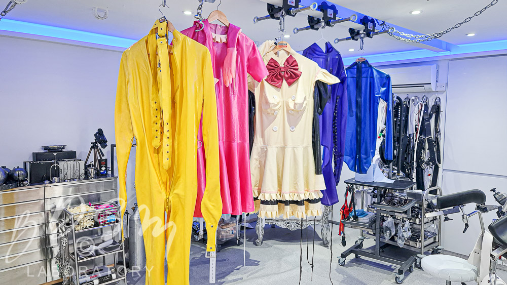 Various rubber outfits hanging in the BDSM Laboratory