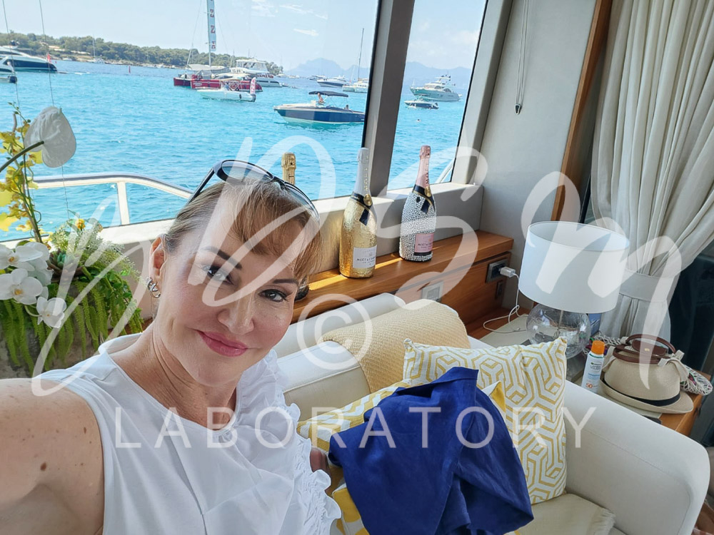 Mistress Miranda - July Adventures 2 Mistress Miranda smiling with the sea and boats in the background