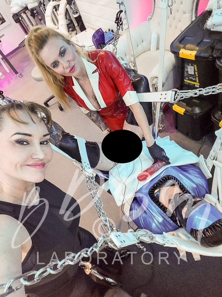 Mistress Miranda and Miss Maxwell with sub in rubber maid outfit